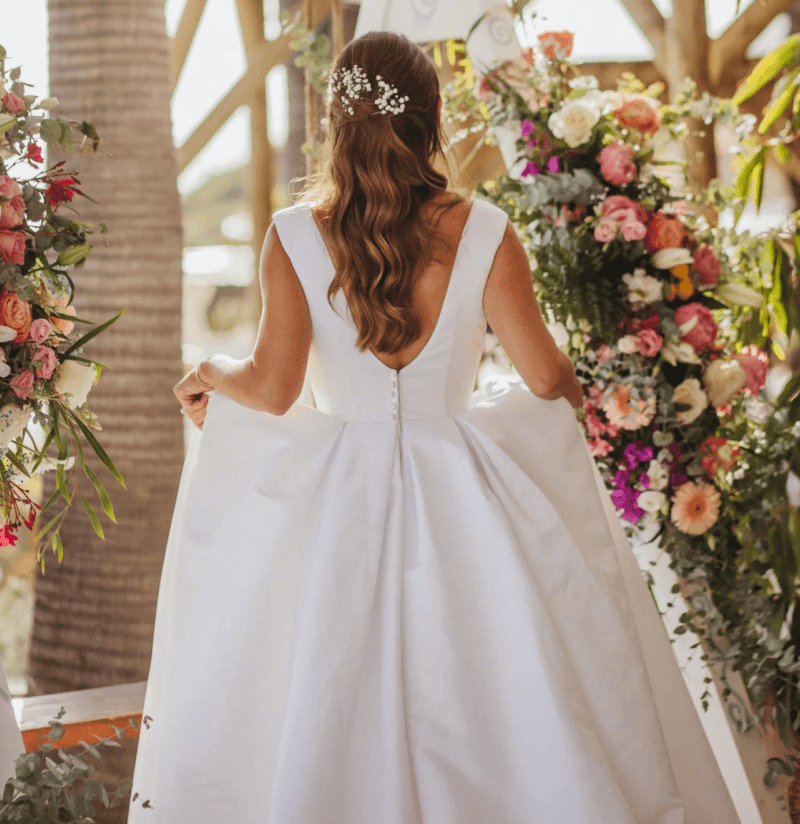 Bride under a floral wedding arch